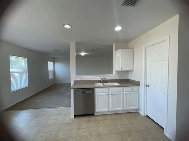 a view of a kitchen with sink cabinets and wooden floor