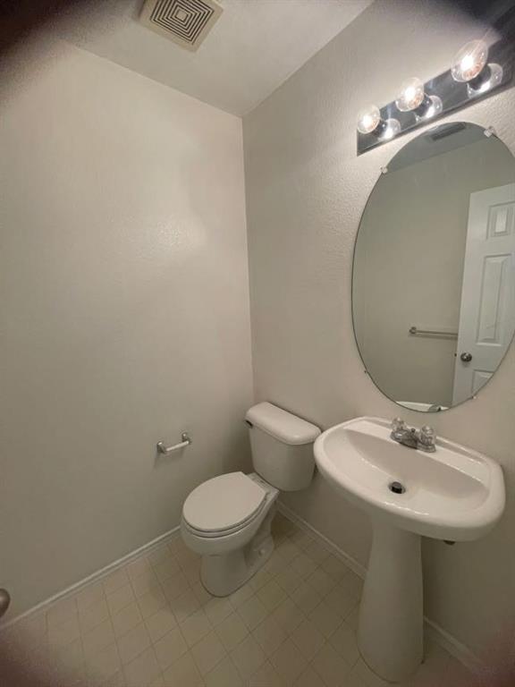 12645 Pricklybranch Drive Fort Worth, TX 76244 - Photo 6 of 21 a bathroom with a sink toilet and a mirror