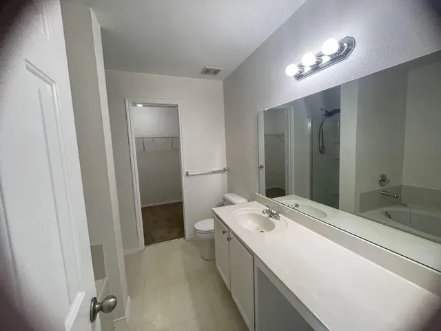 a bathroom with a glass shower door
