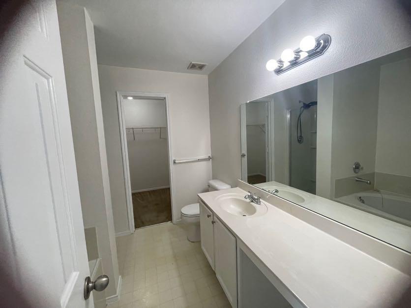 12645 Pricklybranch Drive Fort Worth, TX 76244 - Photo 10 of 21 a bathroom with a double vanity sink and mirror