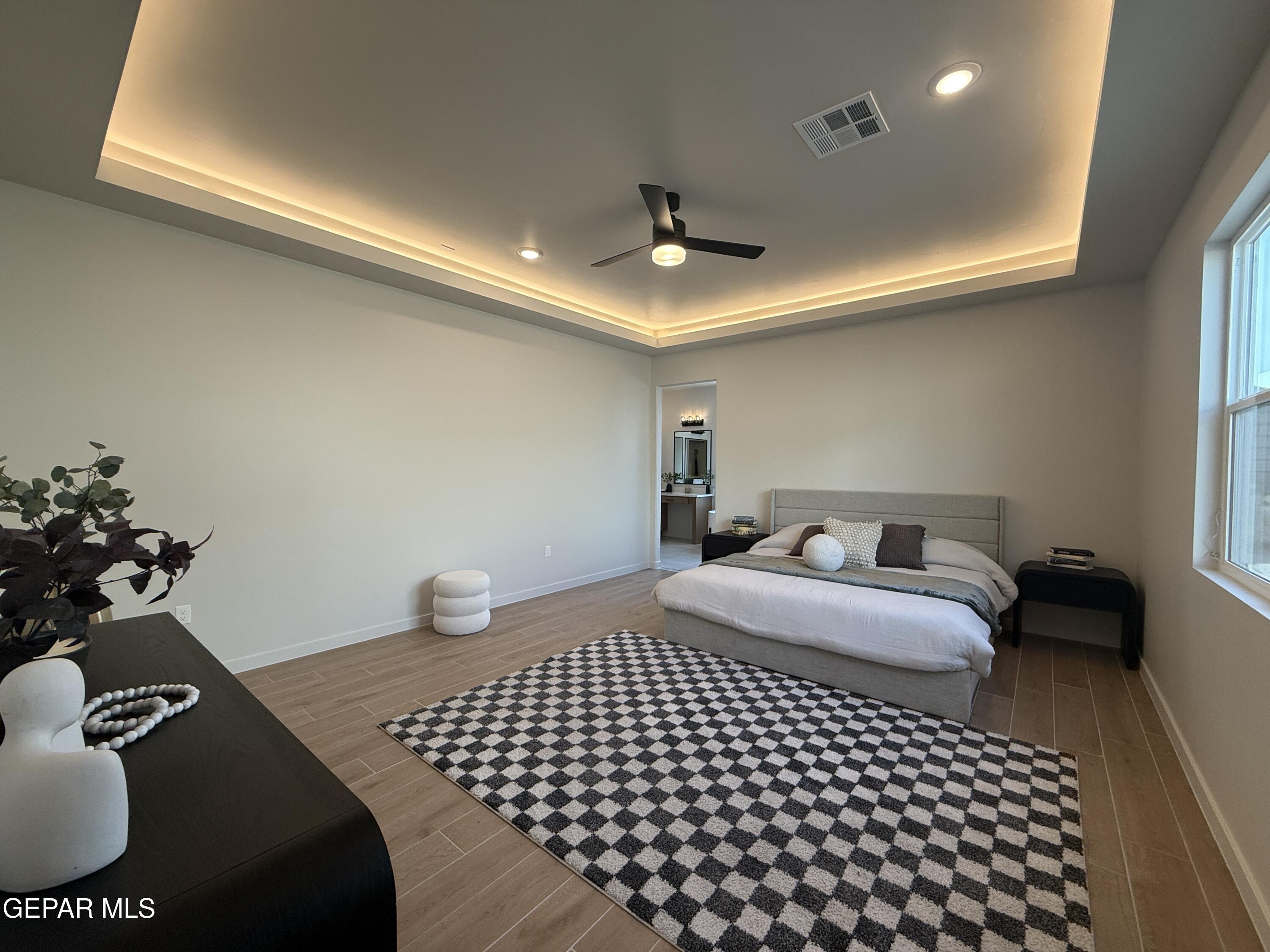 12505 Exton Court El Paso, TX 79928 - Photo 11 of 28 a bedroom with a bed and a couch