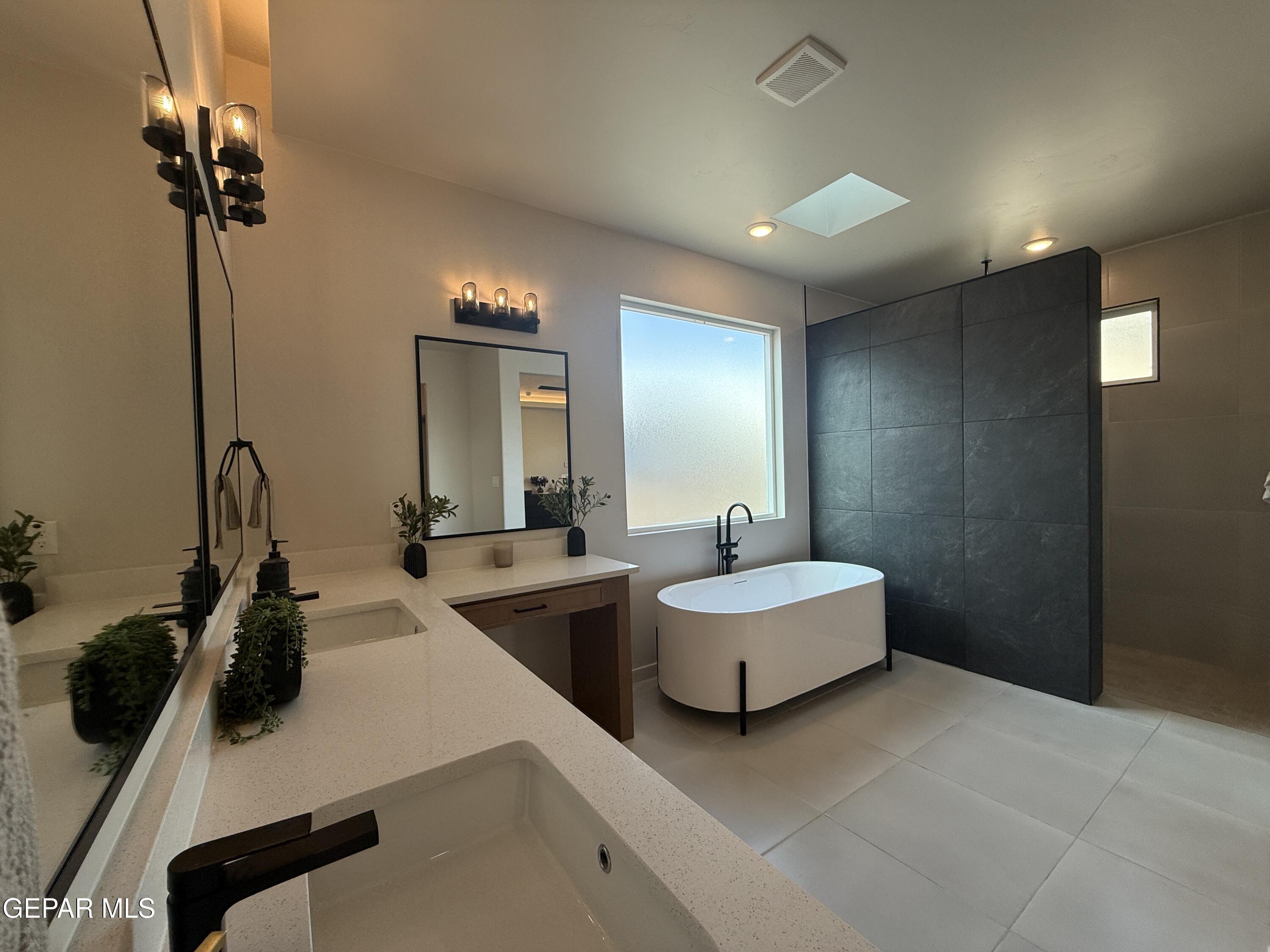 12505 Exton Court El Paso, TX 79928 - Photo 13 of 28 a bathroom with double vanity and two mirrors