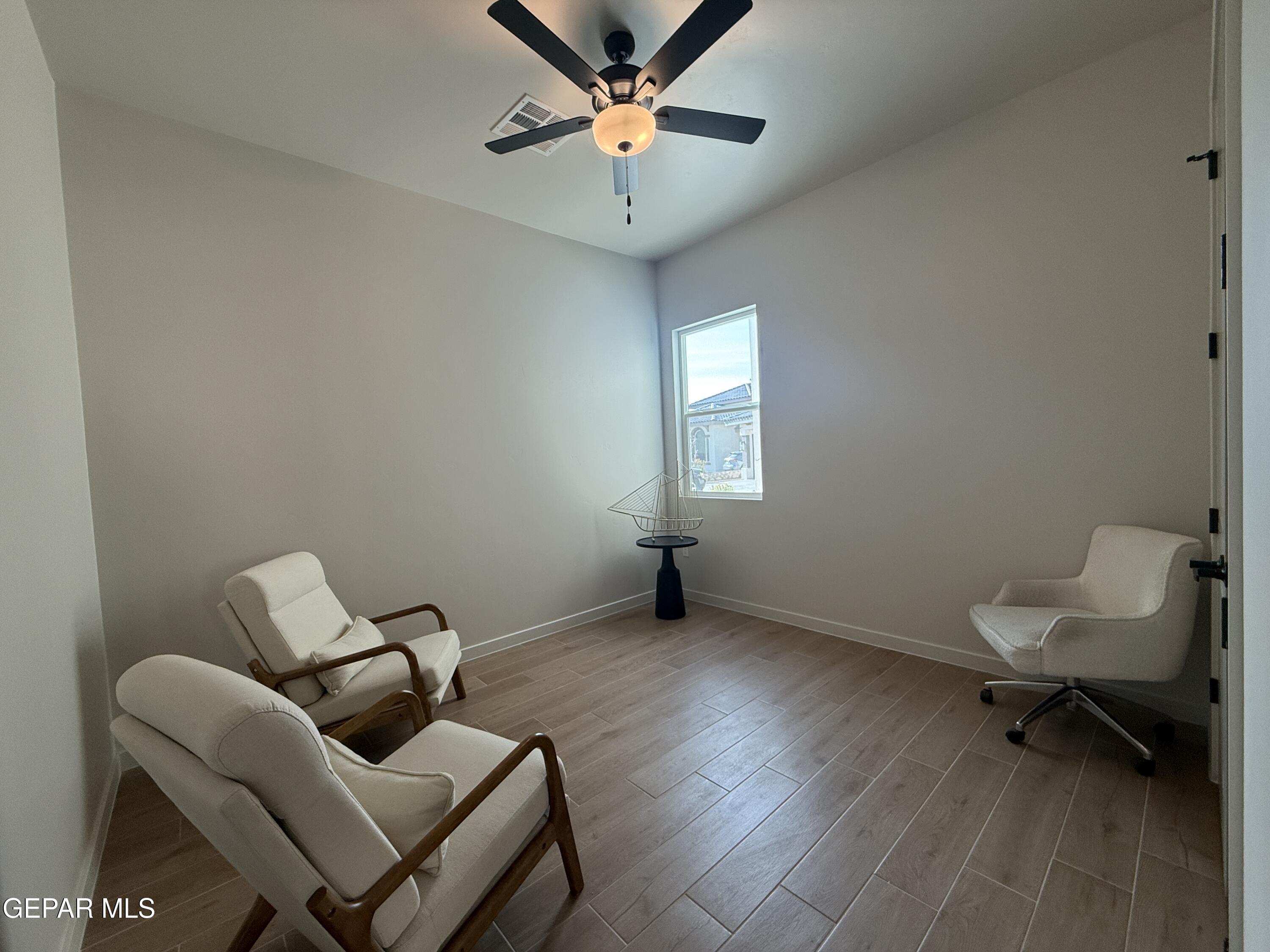 12505 Exton Court El Paso, TX 79928 - Photo 17 of 28 a view of a workspace with furniture and a window