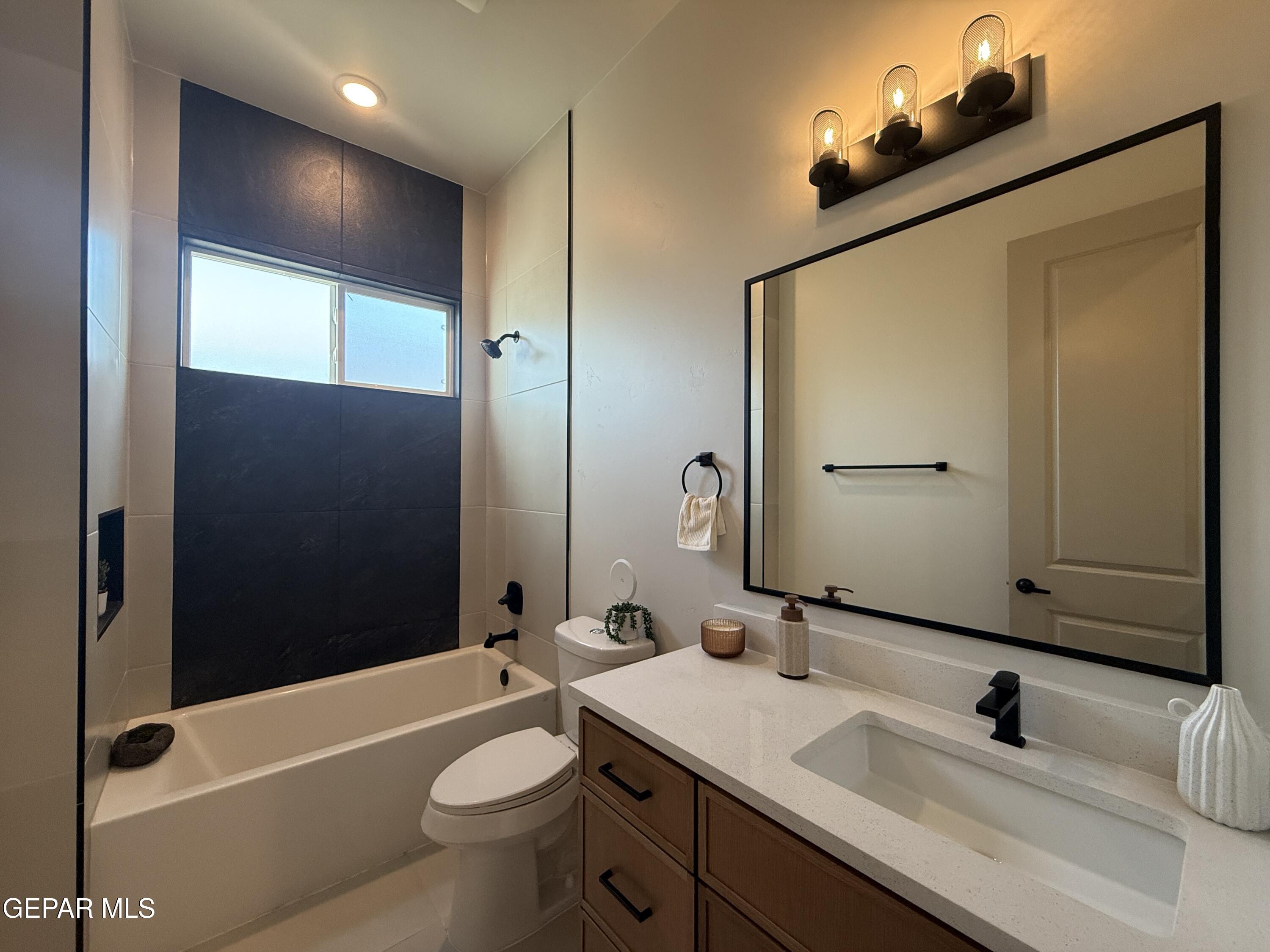 12505 Exton Court El Paso, TX 79928 - Photo 18 of 28 a bathroom with a sink a toilet a mirror and shower
