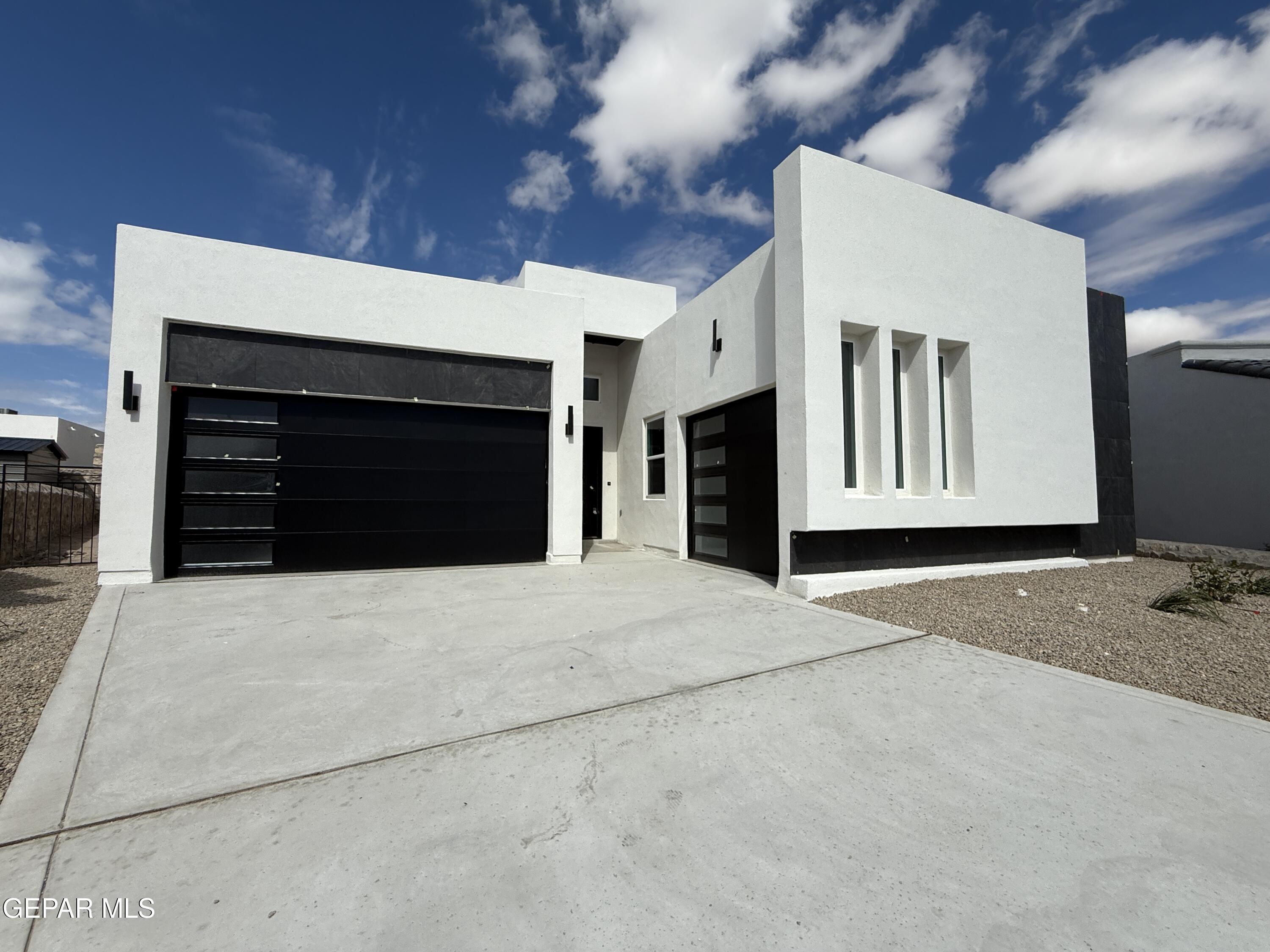 12505 Exton Court El Paso, TX 79928 - Photo 2 of 28 a front view of a house with a yard and garage