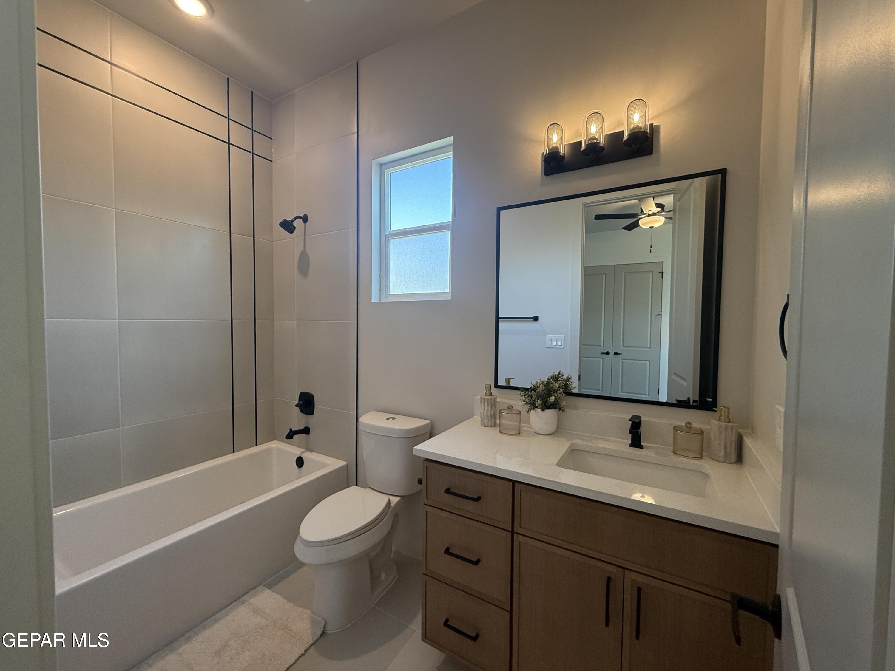 12505 Exton Court El Paso, TX 79928 - Photo 21 of 28 a bathroom with a toilet a sink a tub and mirror