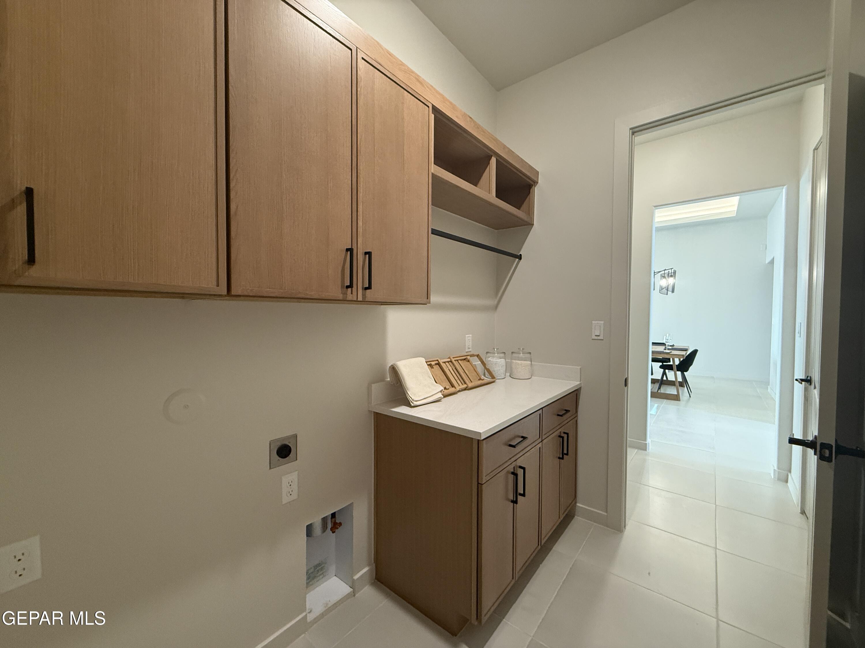 12505 Exton Court El Paso, TX 79928 - Photo 23 of 28 a utility room with cabinets washer and dryer