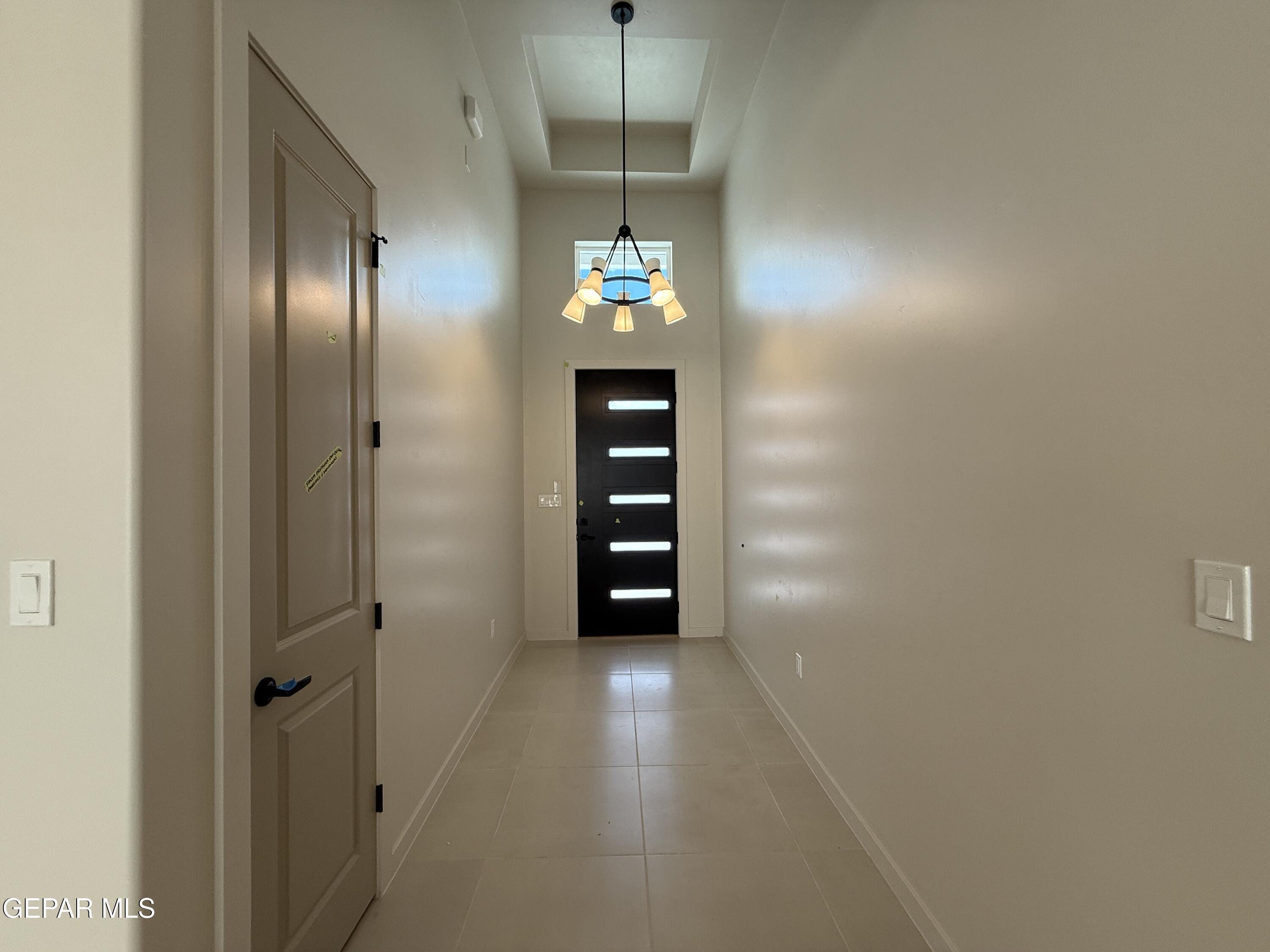12505 Exton Court El Paso, TX 79928 - Photo 4 of 28 a view of a hallway with wooden shelves