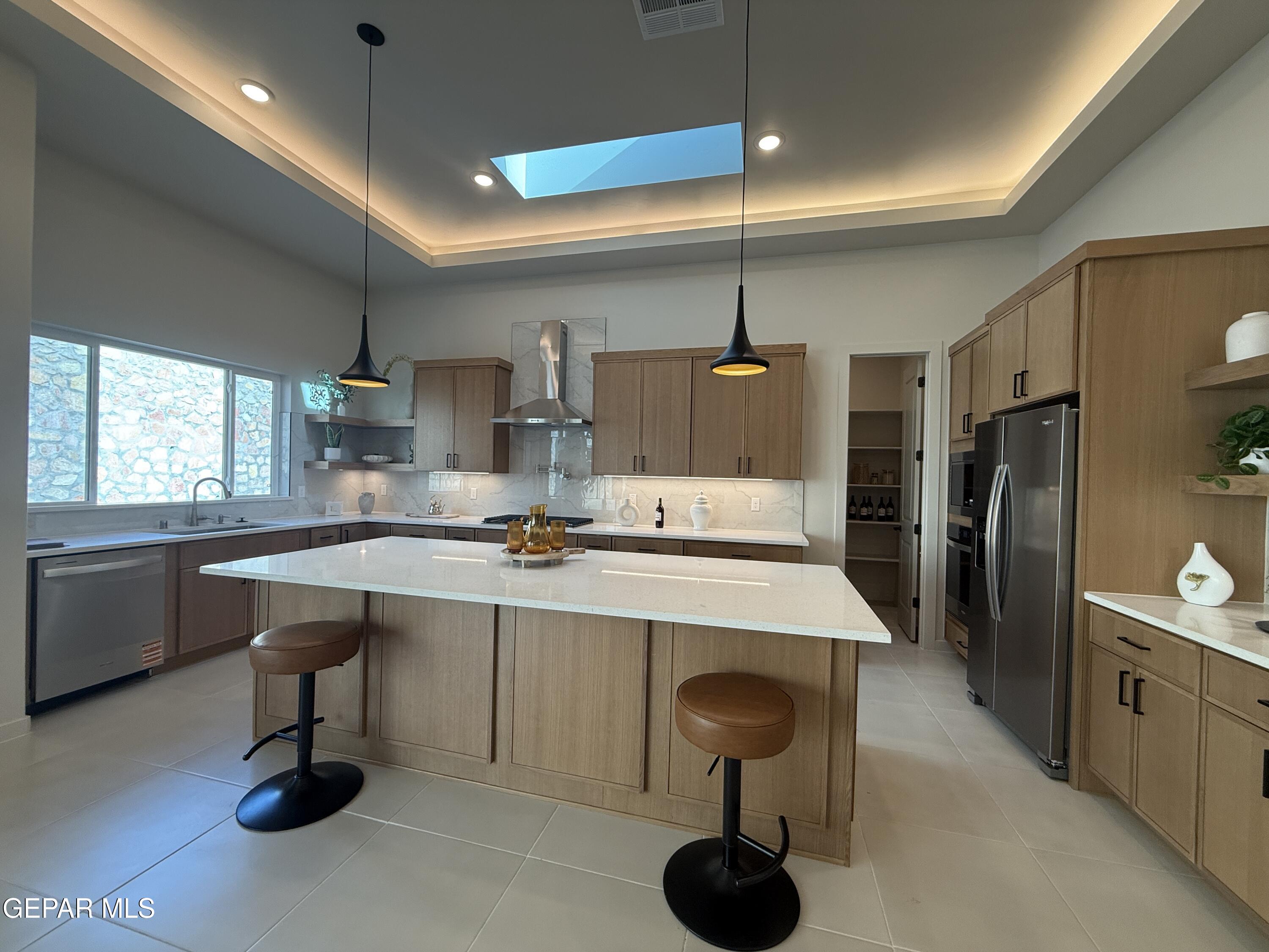12505 Exton Court El Paso, TX 79928 - Photo 7 of 28 a kitchen with a sink refrigerator and cabinets