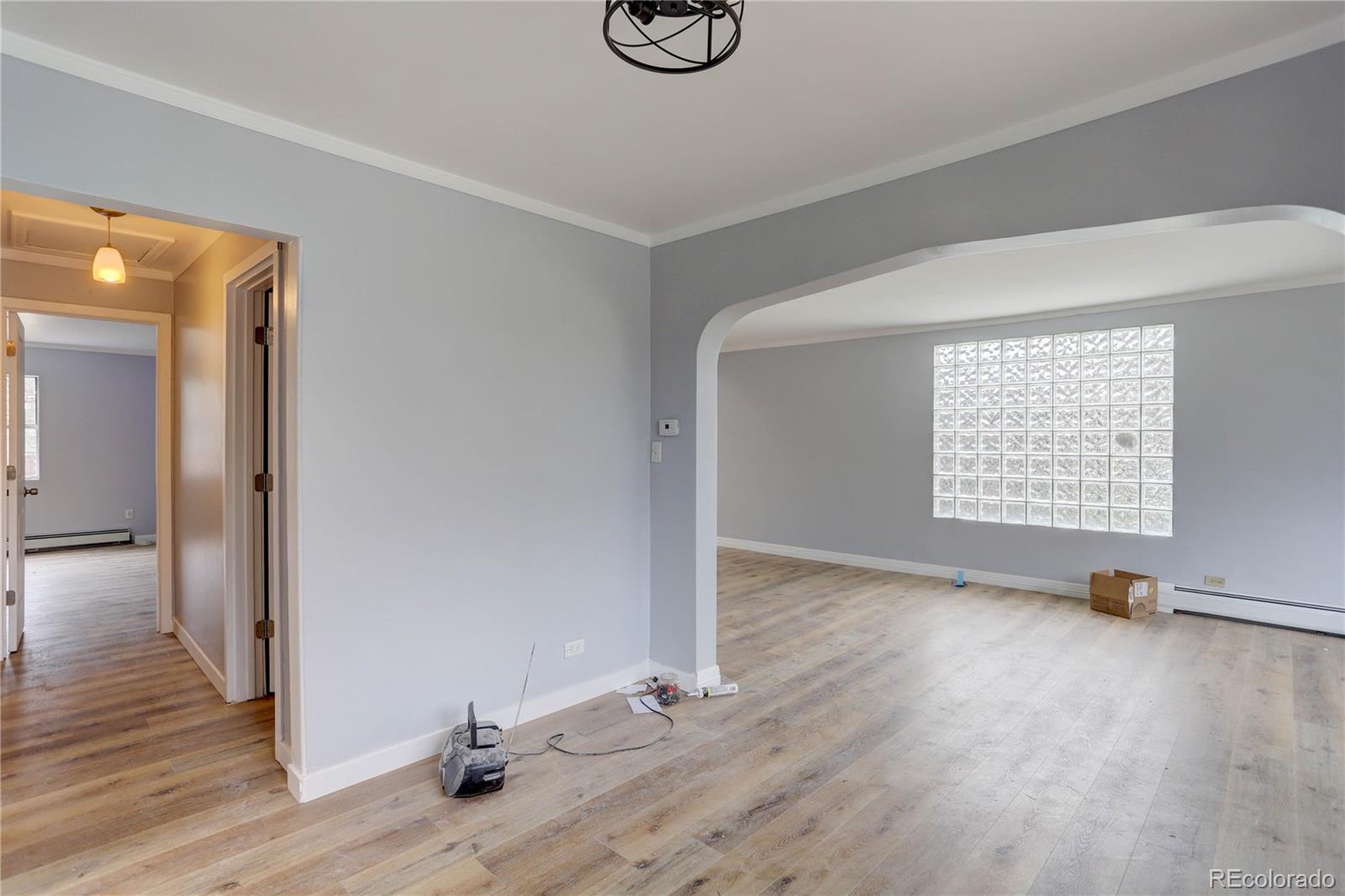 4315 Balsam Street Wheat Ridge, CO 80033 - Photo 11 of 34 a view of an empty room with wooden floor and a window