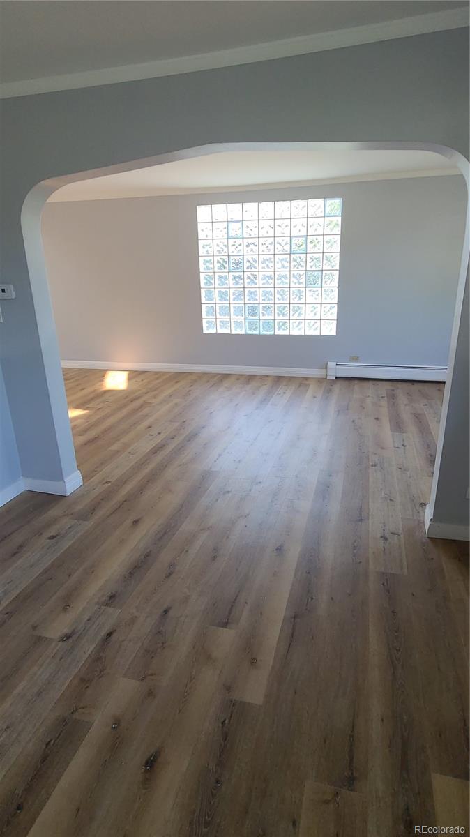 4315 Balsam Street Wheat Ridge, CO 80033 - Photo 12 of 34 a view of an empty room with wooden floor and a window