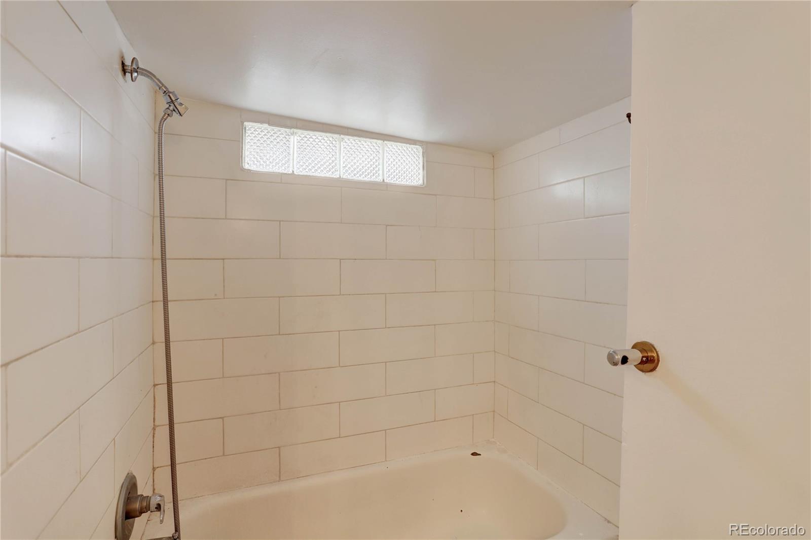 4315 Balsam Street Wheat Ridge, CO 80033 - Photo 20 of 34 a bathroom with a bathtub