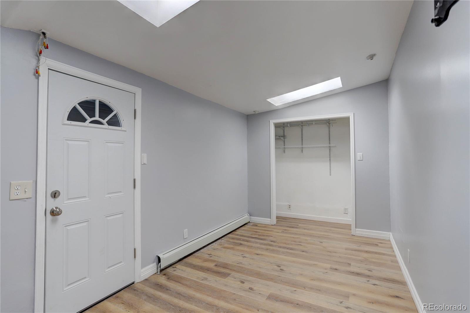 4315 Balsam Street Wheat Ridge, CO 80033 - Photo 2 of 34 a view of an empty room with wooden floor