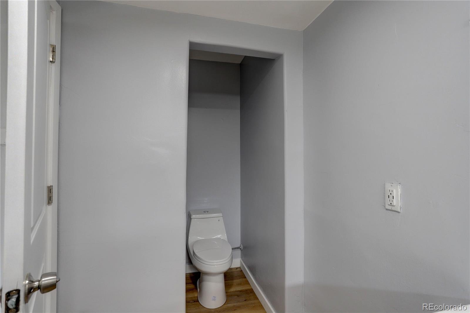 4315 Balsam Street Wheat Ridge, CO 80033 - Photo 23 of 34 a white toilet sitting next to a white wall