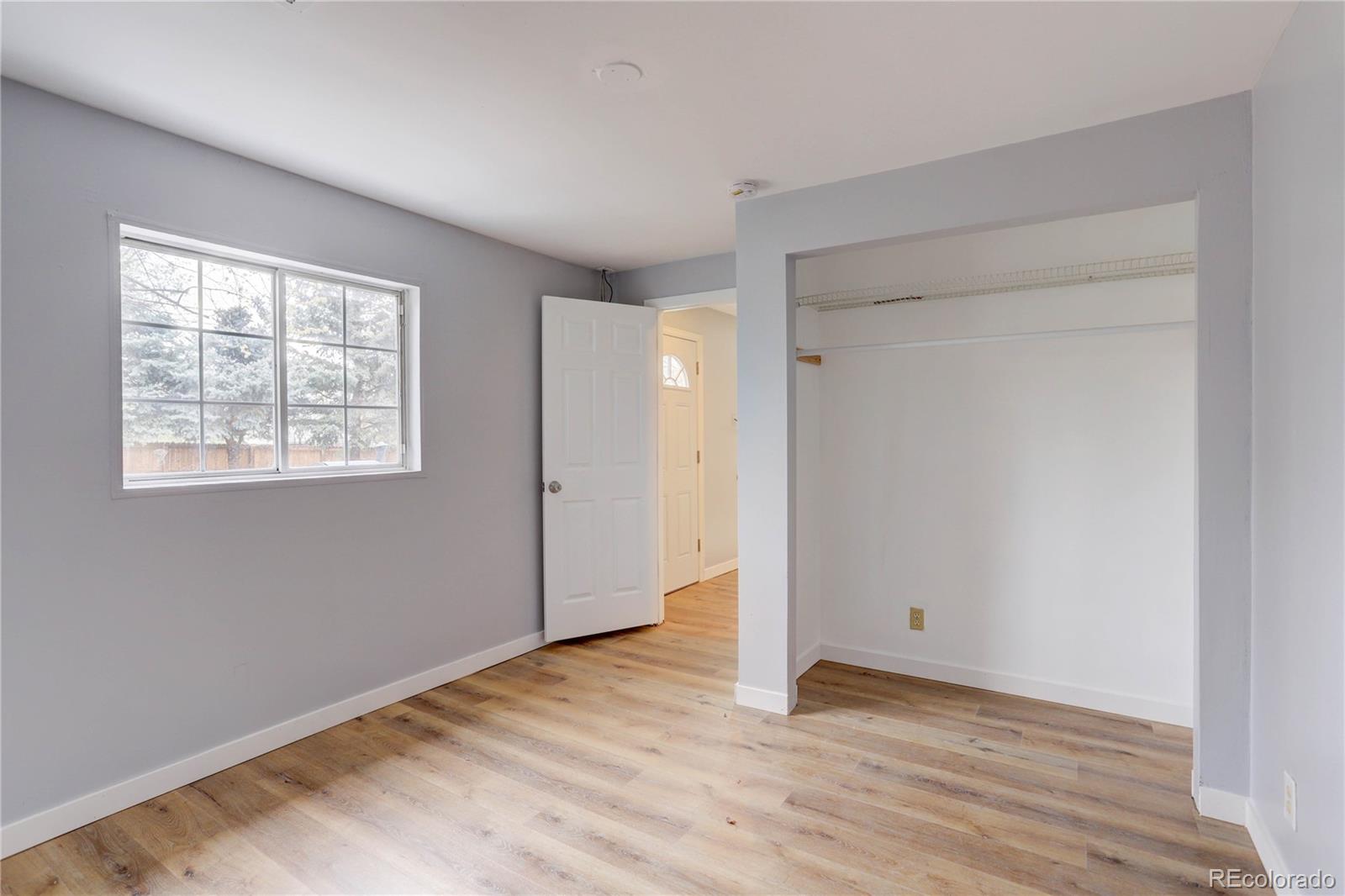 4315 Balsam Street Wheat Ridge, CO 80033 - Photo 27 of 34 a view of an empty room with wooden floor and a window