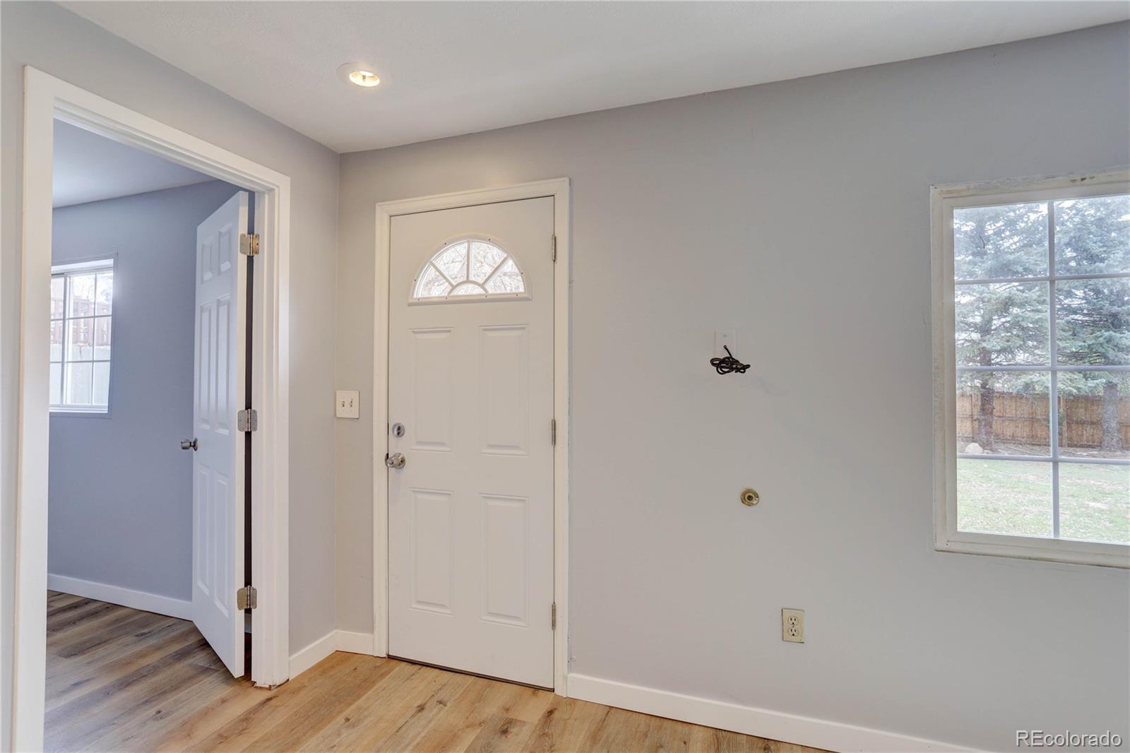 4315 Balsam Street Wheat Ridge, CO 80033 - Photo 3 of 34 a view of an empty room with wooden floor and a window