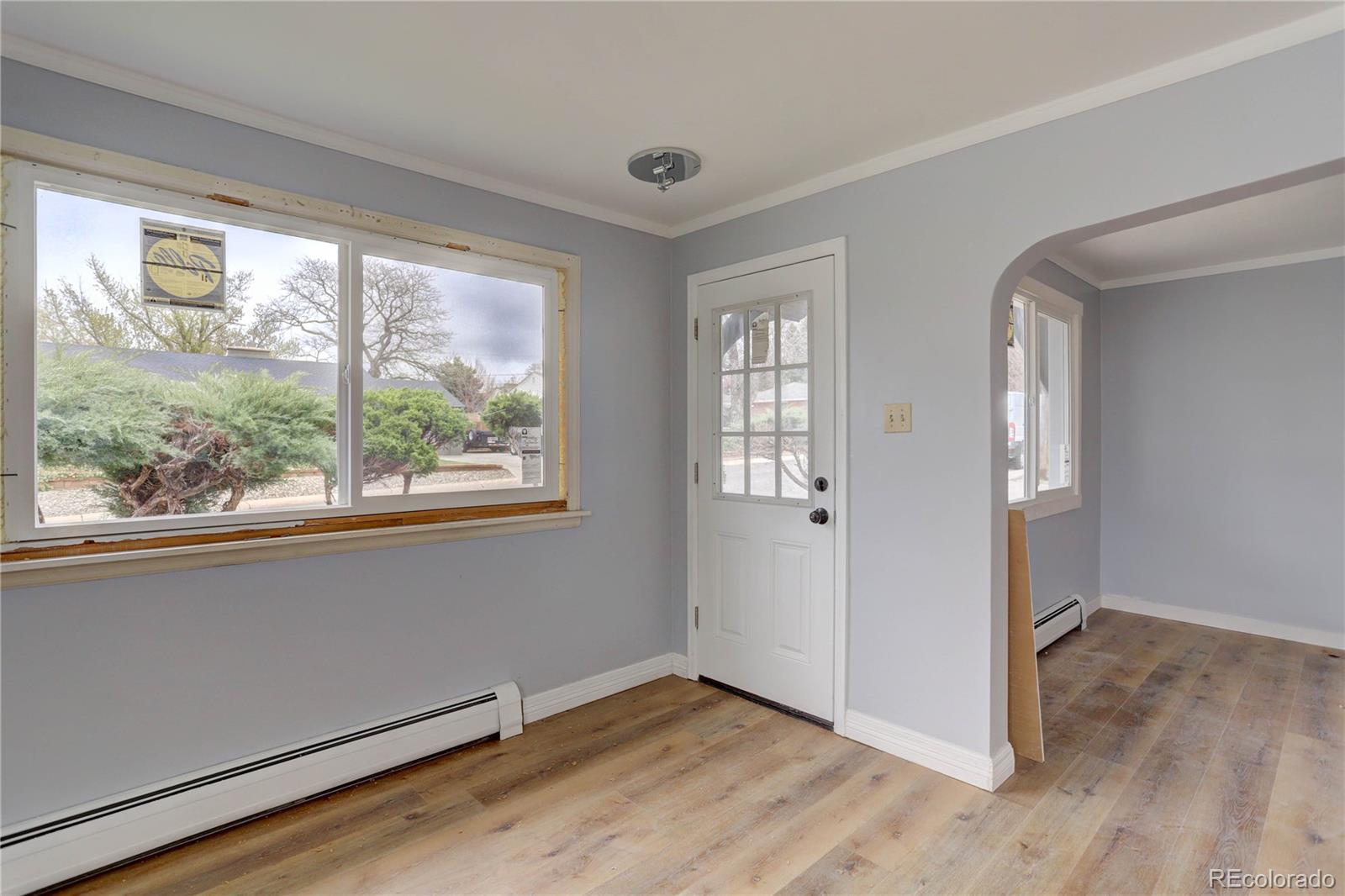 4315 Balsam Street Wheat Ridge, CO 80033 - Photo 4 of 34 an empty room with wooden floor and windows
