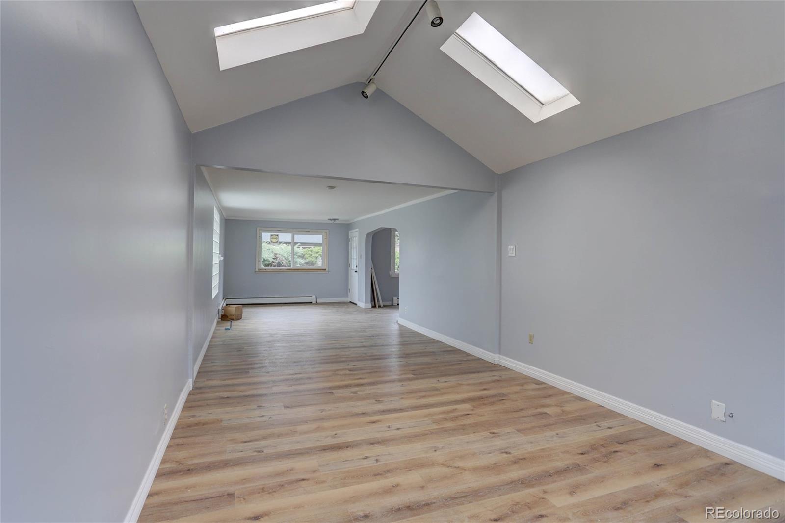 4315 Balsam Street Wheat Ridge, CO 80033 - Photo 6 of 34 wooden floor in an empty room with a window