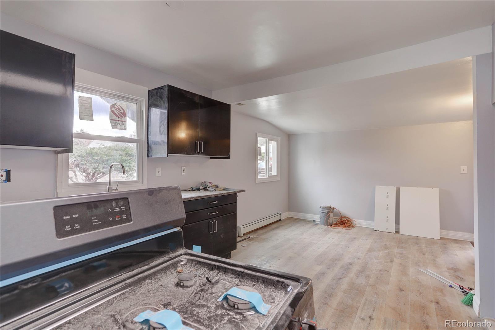 4315 Balsam Street Wheat Ridge, CO 80033 - Photo 7 of 34 a living room with furniture and a flat screen tv