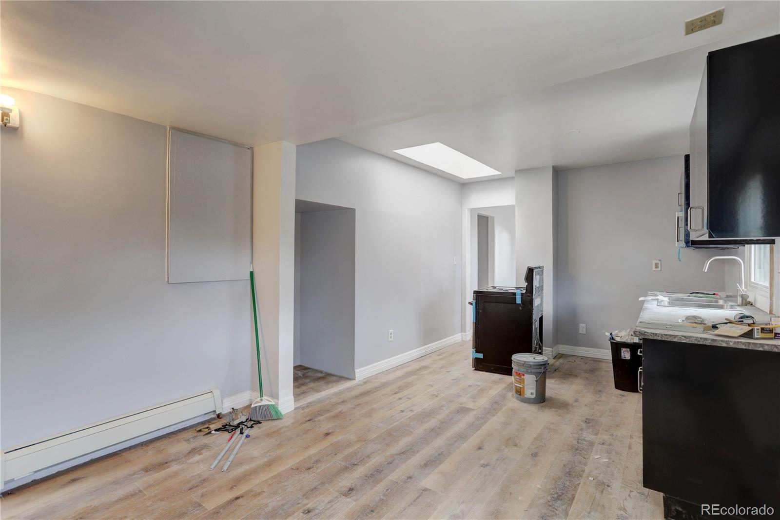 4315 Balsam Street Wheat Ridge, CO 80033 - Photo 10 of 34 a view of a workspace with furniture and a flat screen tv