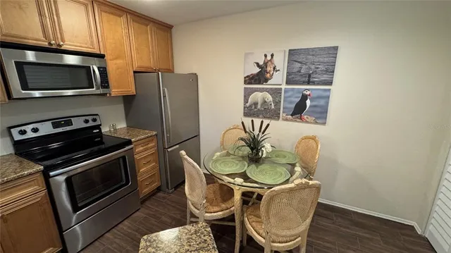 a kitchen with stainless steel appliances a microwave a stove and a refrigerator