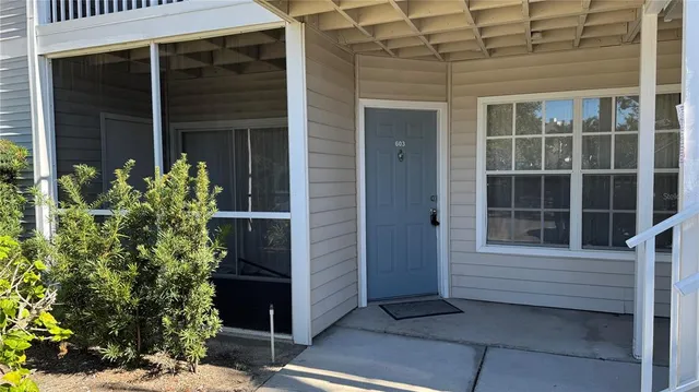 a view of front door and potted plants