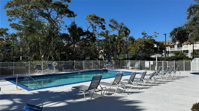 a view of a lake with a table and chairs