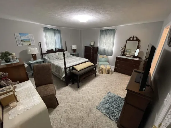 a bedroom with a bed and dresser