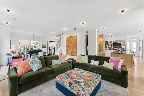 a living room with furniture kitchen view and a table