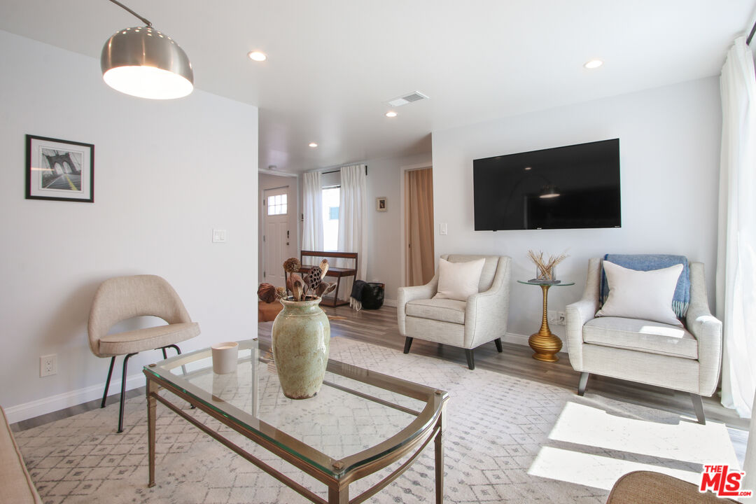 6438 Rhea Avenue Reseda, CA 91335 - Photo 3 of 9 a living room with furniture a flat screen tv and a lamp