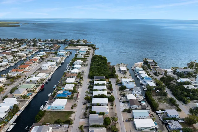 a living room with furniture kitchen view and a window