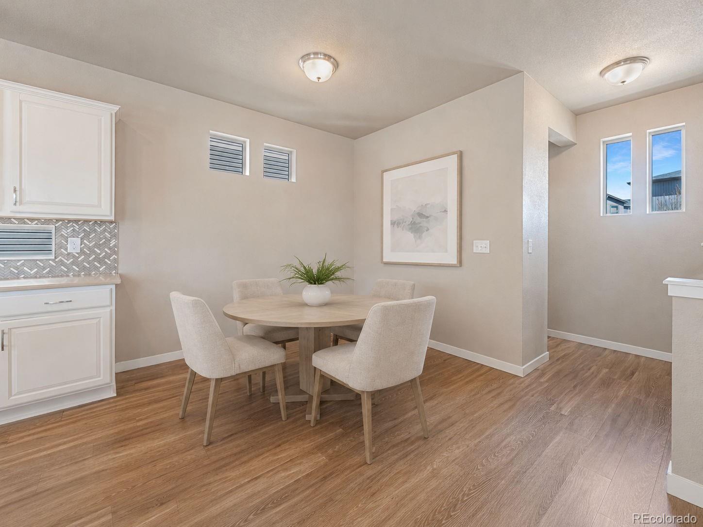 9528 Timberlake Loop Colorado Springs, CO 80927 - Photo 4 of 37 a view of a dining room with furniture and wooden floor