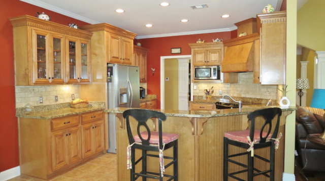 320 Eagle Ridge Road Macon, GA 31216 - Photo 11 of 35 a kitchen with a table chairs refrigerator and cabinets
