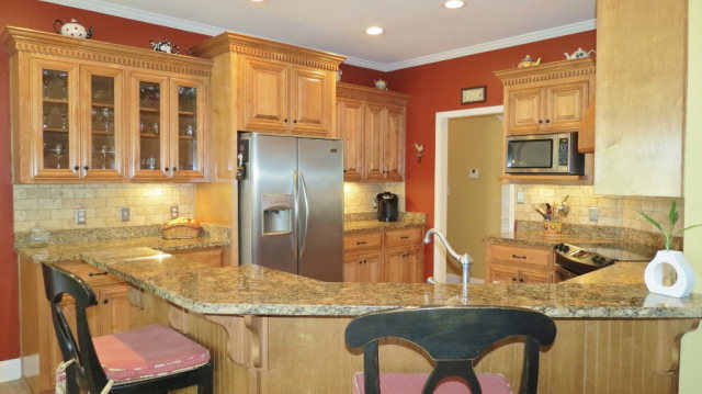 320 Eagle Ridge Road Macon, GA 31216 - Photo 12 of 35 a kitchen with granite countertop a sink stainless steel appliances and cabinets