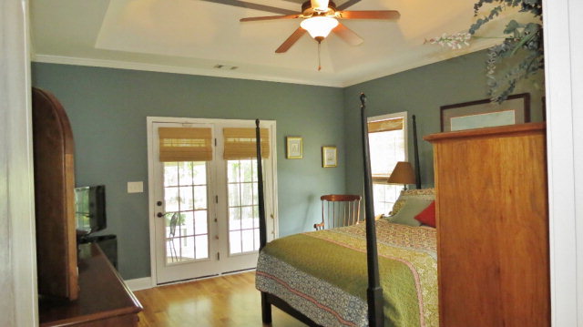 320 Eagle Ridge Road Macon, GA 31216 - Photo 18 of 35 a bedroom with a bed and chandelier