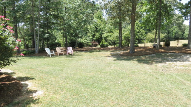 320 Eagle Ridge Road Macon, GA 31216 - Photo 28 of 35 a view of a backyard with table and chairs and wooden fence