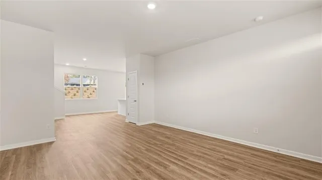 a view of an entryway with wooden floor and door