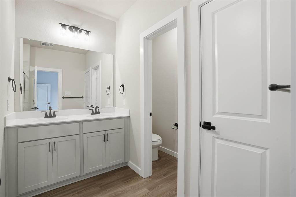 1606 Governors Boulevard Heath, TX 75126 - Photo 21 of 37 Bathroom featuring double vanity and light wood finished floors