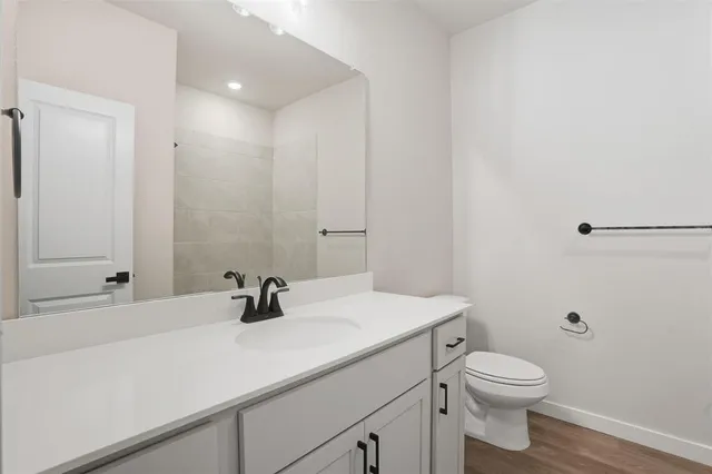 a bathroom with a shower sink and mirror