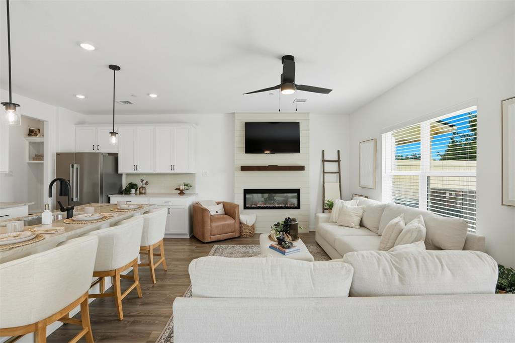 1606 Governors Boulevard Heath, TX 75126 - Photo 9 of 37 Living area featuring dark wood-style flooring, recessed lighting, a large fireplace, and a ceiling fan