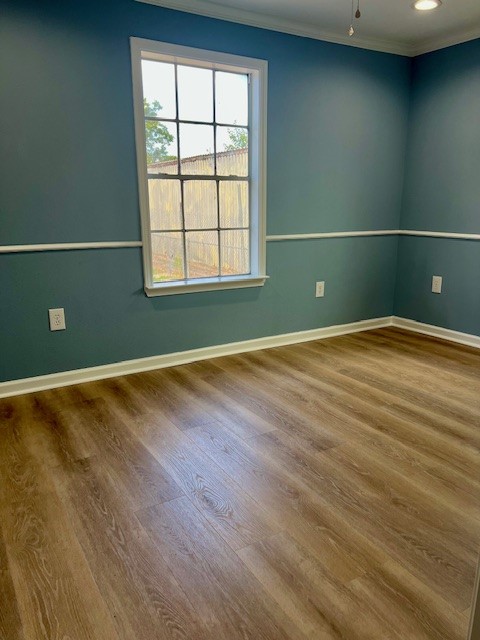 425 Caplin Street Houston, TX 77022 - Photo 6 of 9 an empty room with wooden floor and windows