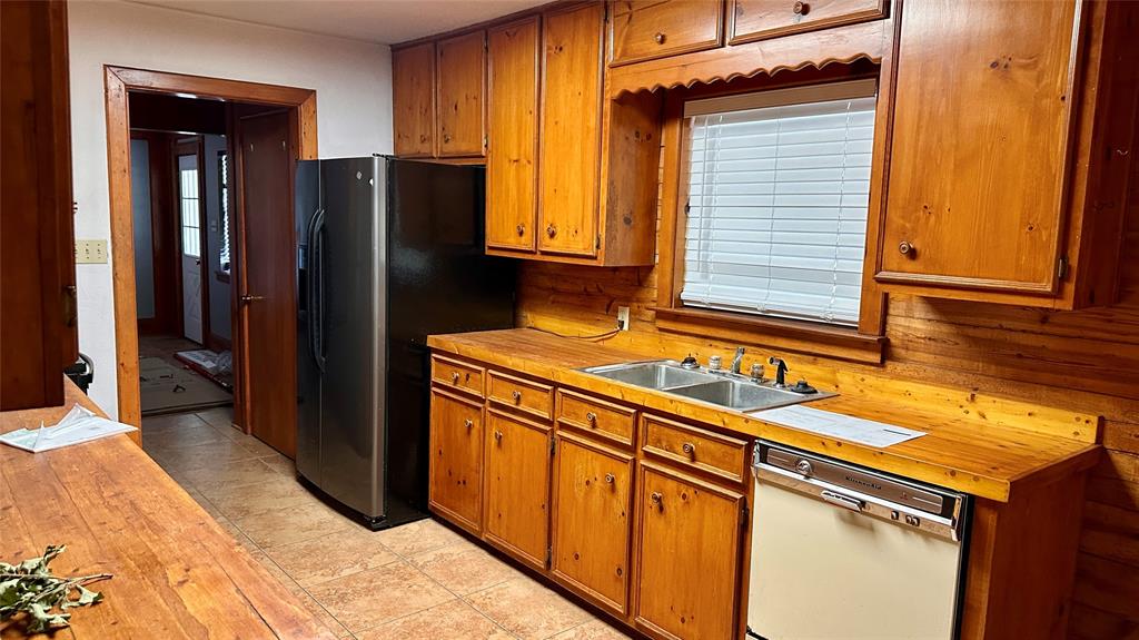 126 Garza Road Shady Shores, TX 76208 - Photo 5 of 19 a view of a kitchen with refrigerator and cabinets