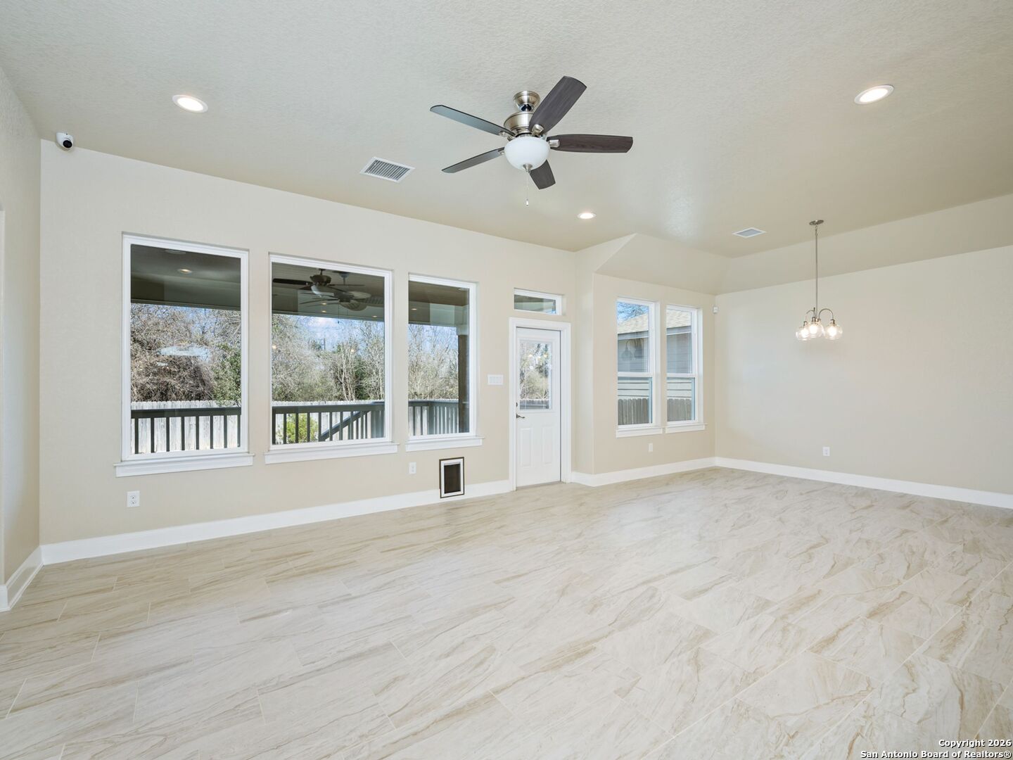 14681 Main Street Lytle, TX 78052 - Photo 12 of 33 a view of an empty room with a window and a ceiling fan