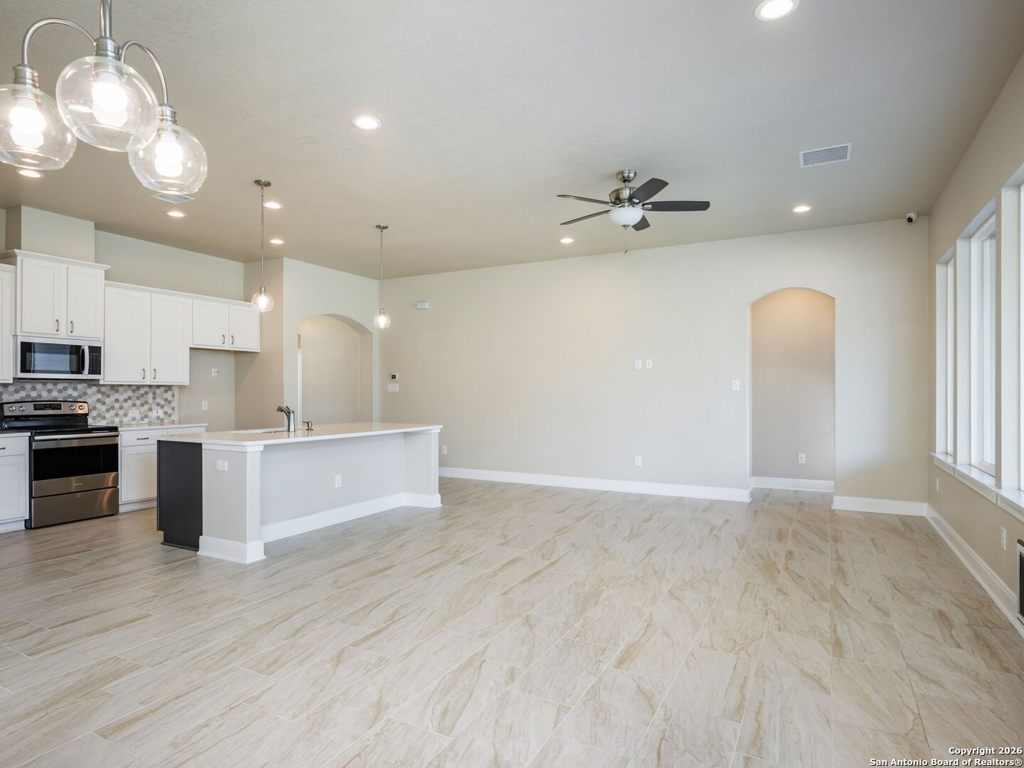 14681 Main Street Lytle, TX 78052 - Photo 14 of 33 a view of kitchen with granite countertop cabinets stainless steel appliances and a fireplace