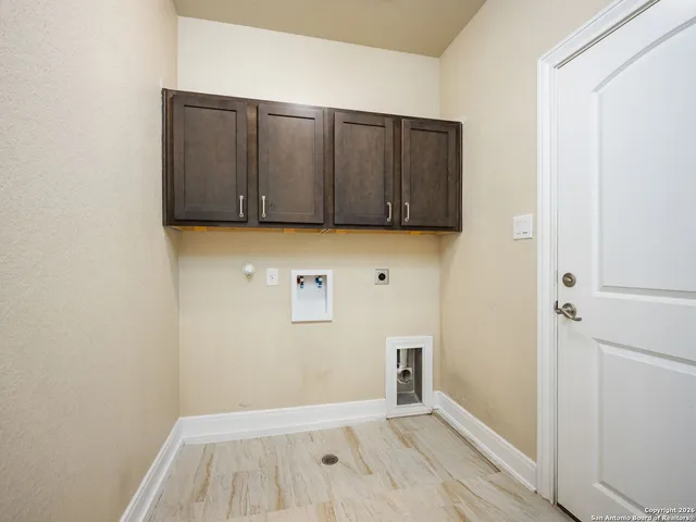 a view of a utility room with wooden floor