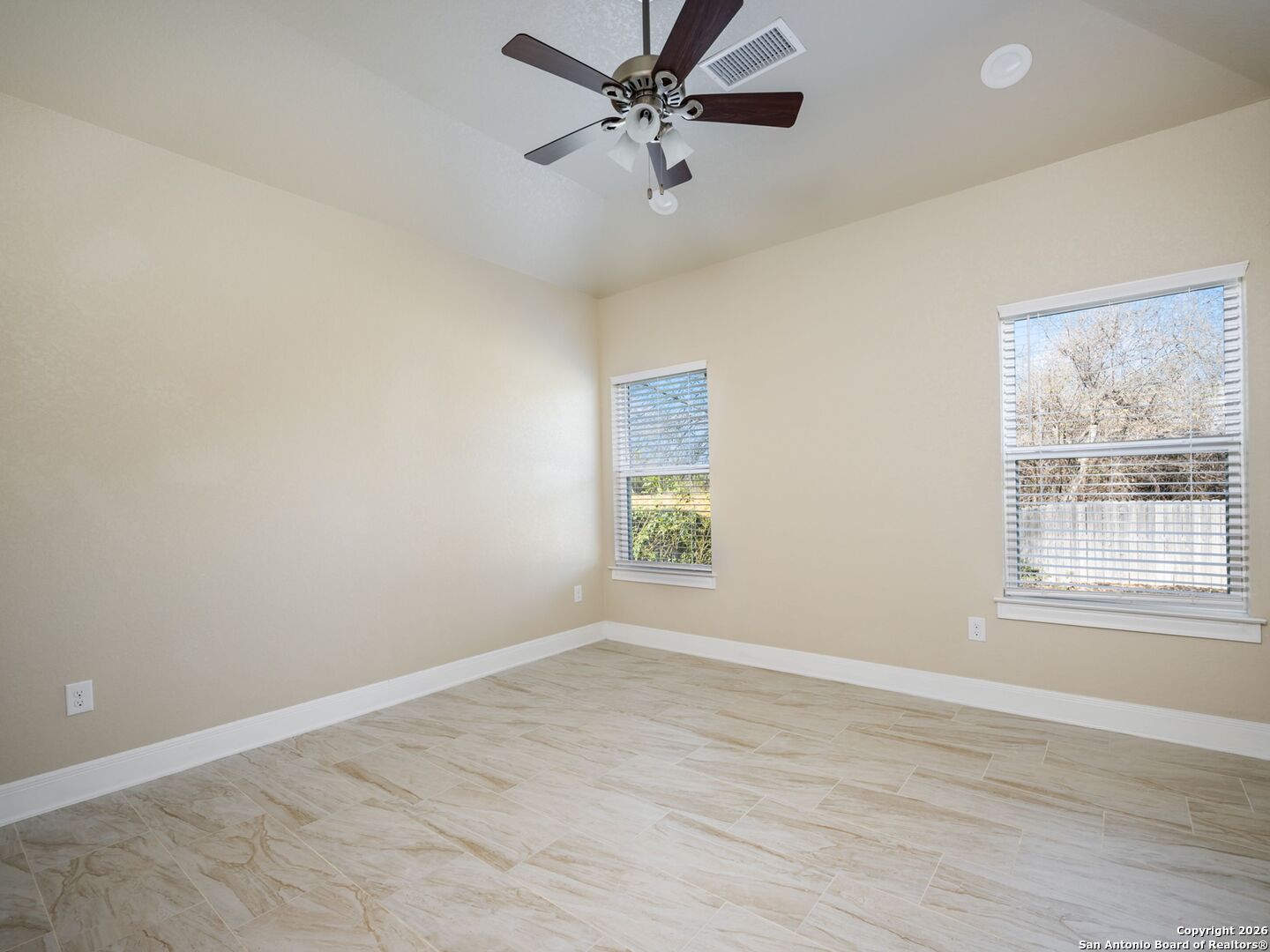 14681 Main Street Lytle, TX 78052 - Photo 19 of 33 an empty room with wooden floor windows and fan