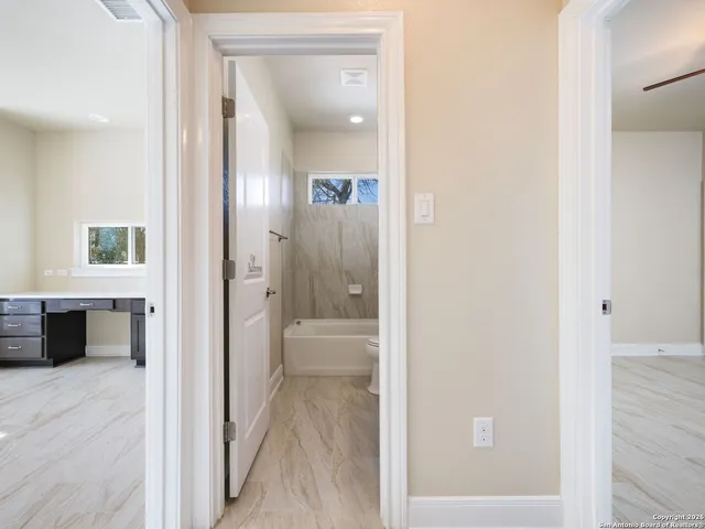 a view of a bathroom from the hallway