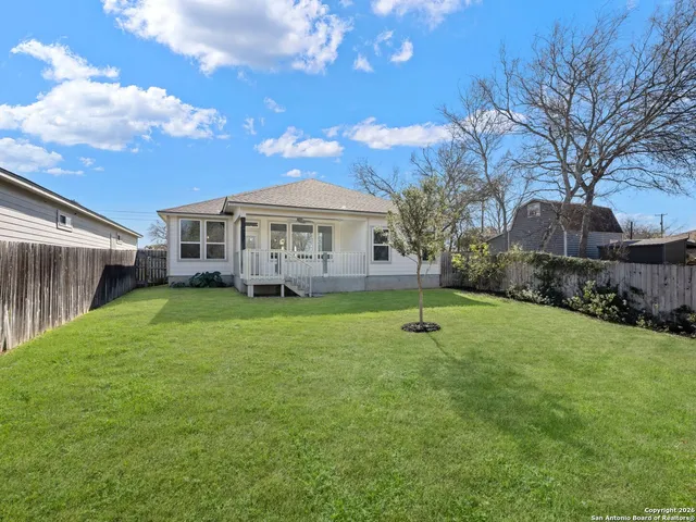 a view of a house with a backyard and a patio