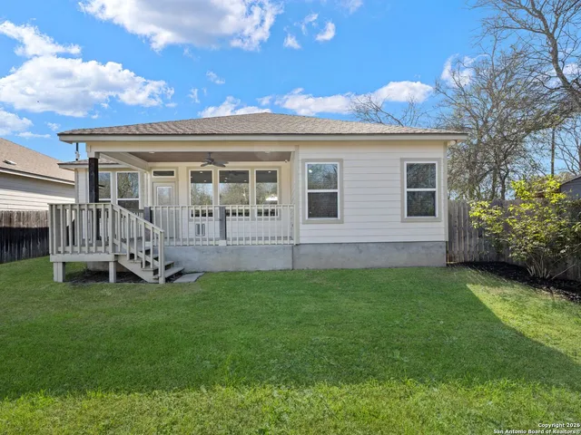 a view of a house with a backyard