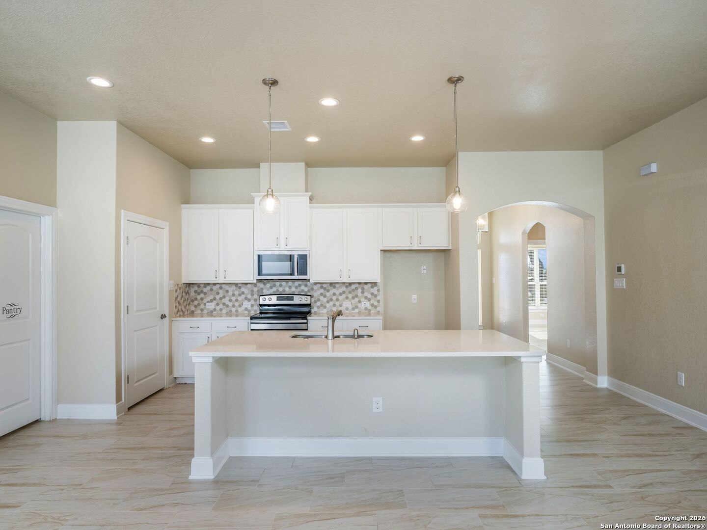 14681 Main Street Lytle, TX 78052 - Photo 5 of 33 a view of a kitchen with kitchen island a sink stainless steel appliances and cabinets